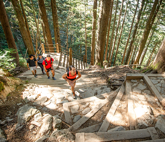 Active senior woman hiking in North Vancouver mountains maintaining bone health